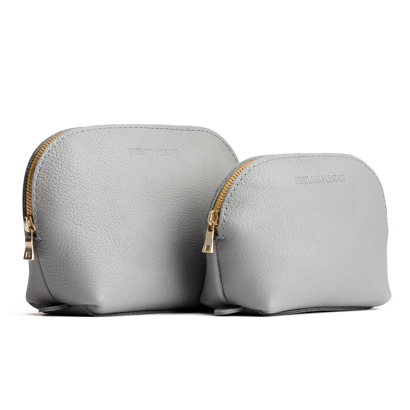 Nimbus | Leather makeup bag with curved top zipper and flat 