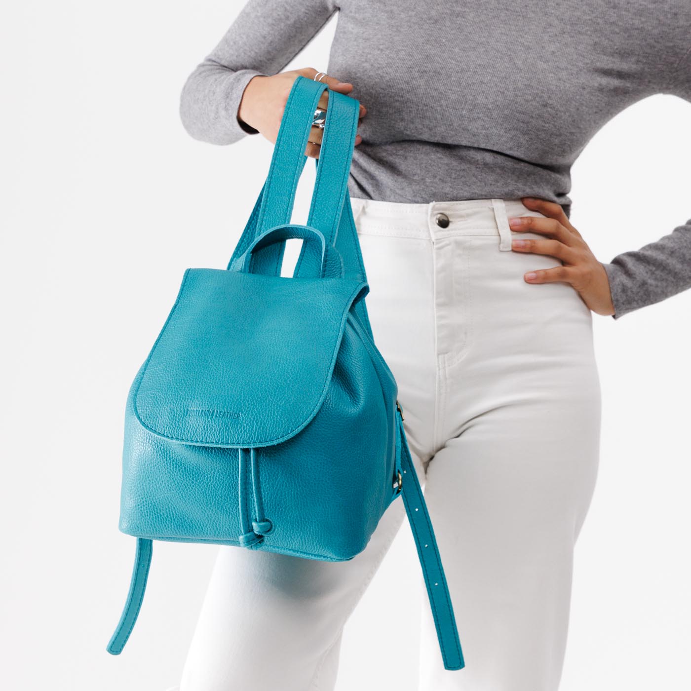 Baja | Model holding slouchy leather bucket backpack