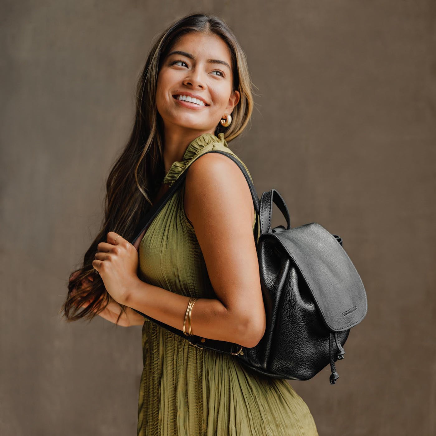 All Color: Pebbled--black | Model wearing slouchy leather bucket backpack