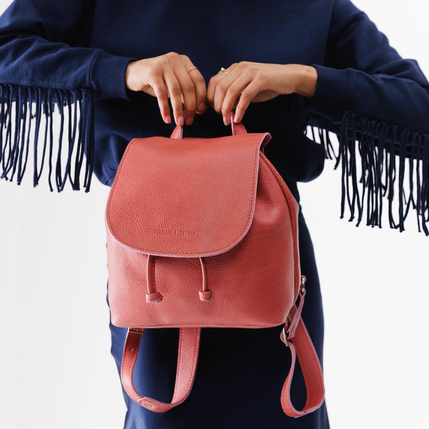 Watermelon | Model holding slouchy leather bucket backpack