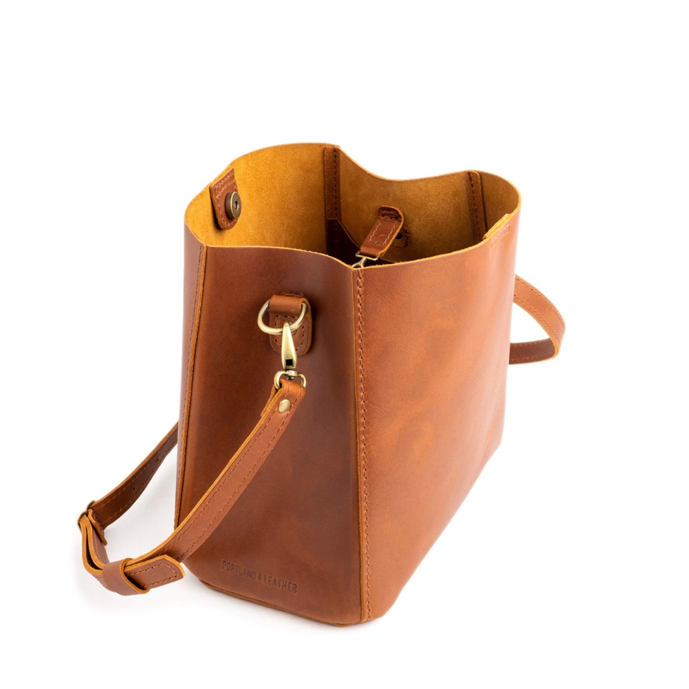 Honey | symmetrical bucket bag with latch closure and removable crossbody strap