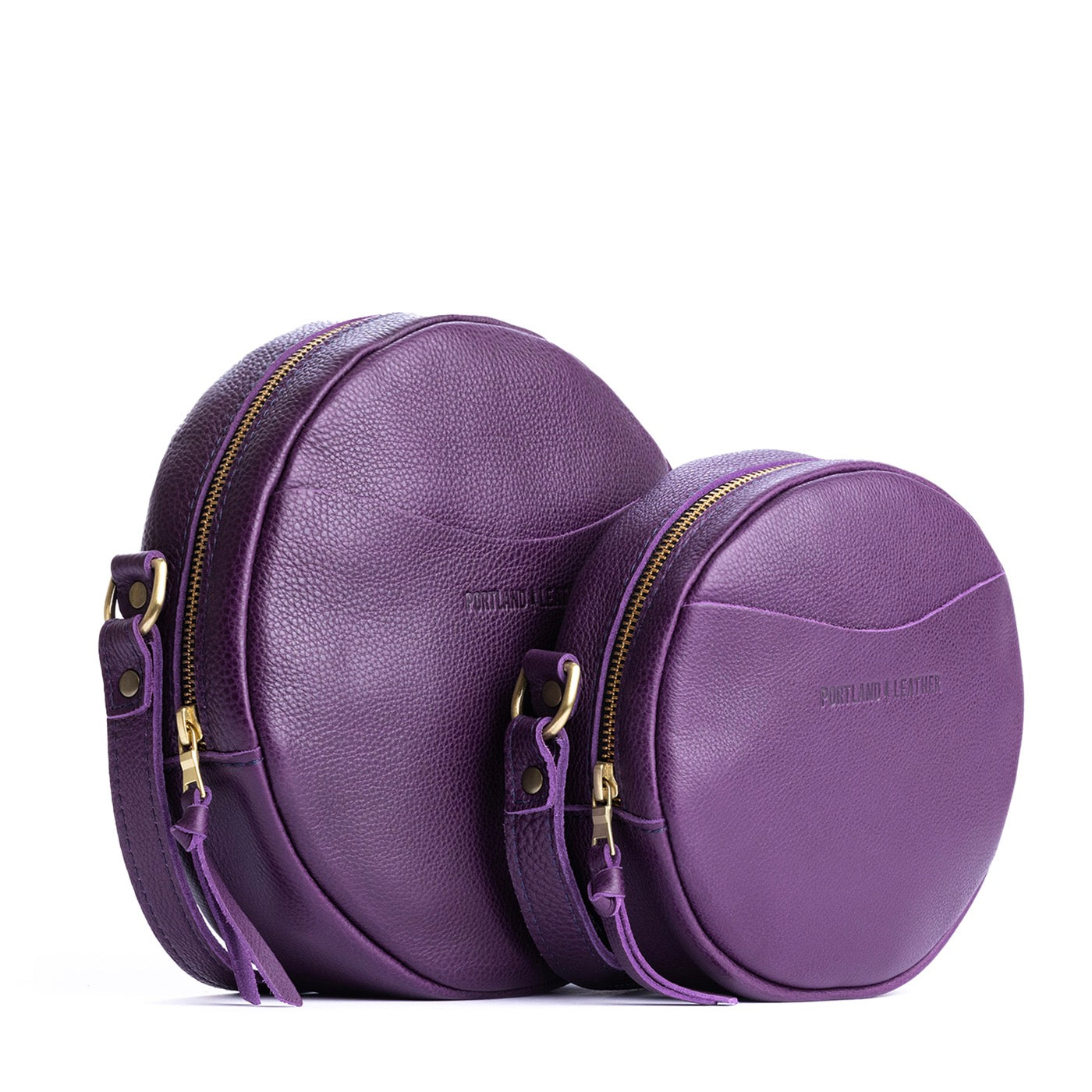 Empire | Side by side of two sizes of circle shaped crossbody bag with top zipper