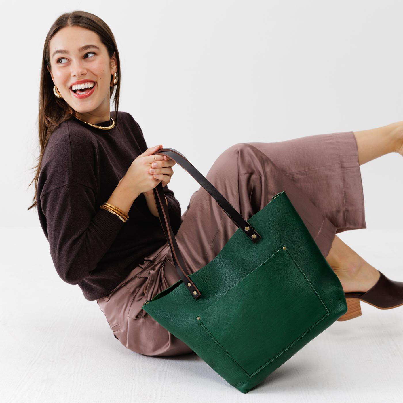 Bacalar Classic  | Model holding large leather tote bag with sturdy bridle handles and front pocket