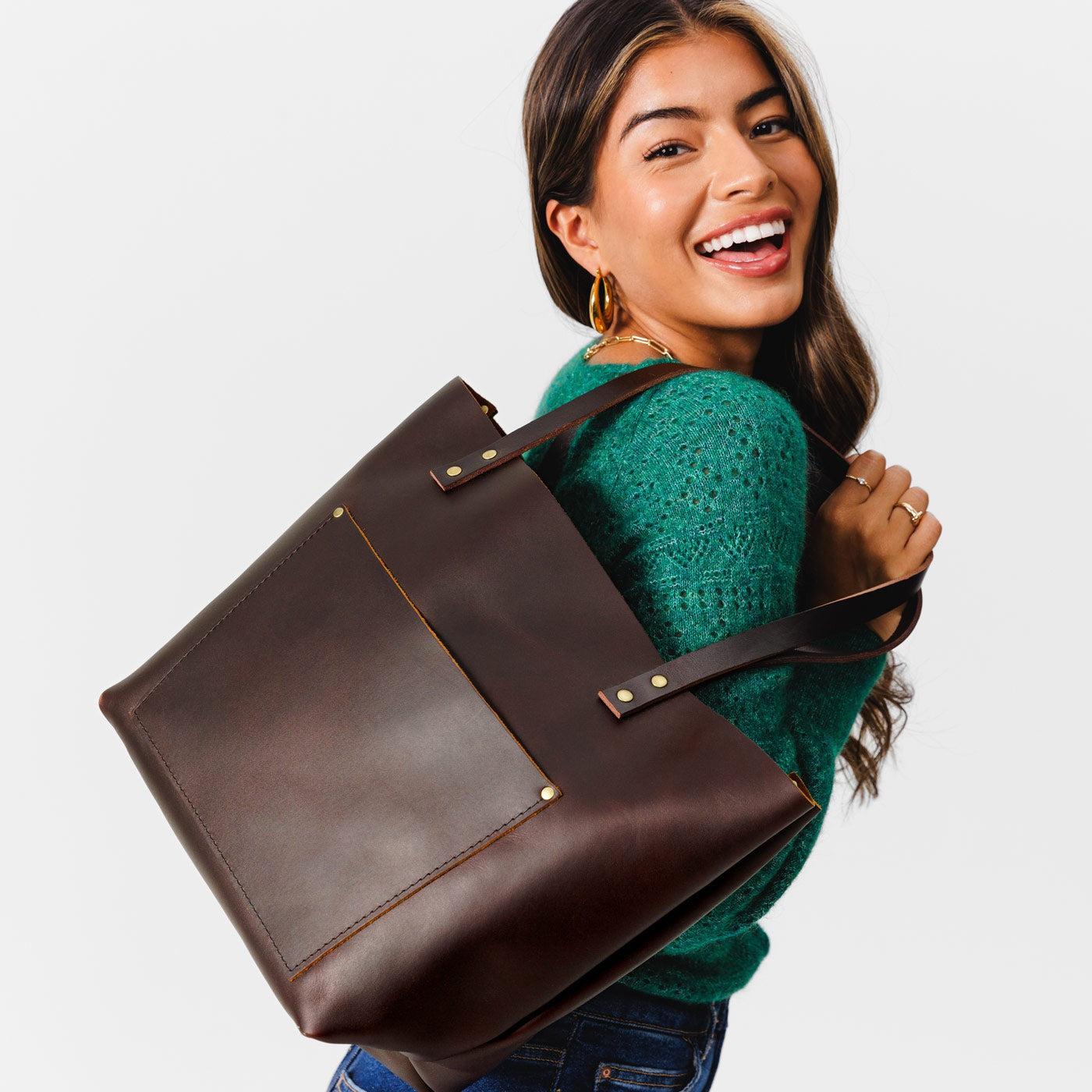 Grizzly*Classic | Model holding large leather tote bag with sturdy bridle handles and front pocket