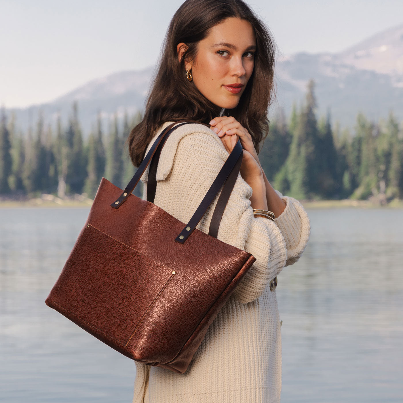 Nutmeg*Classic  | Model holding large leather tote bag with sturdy bridle handles and front pocket