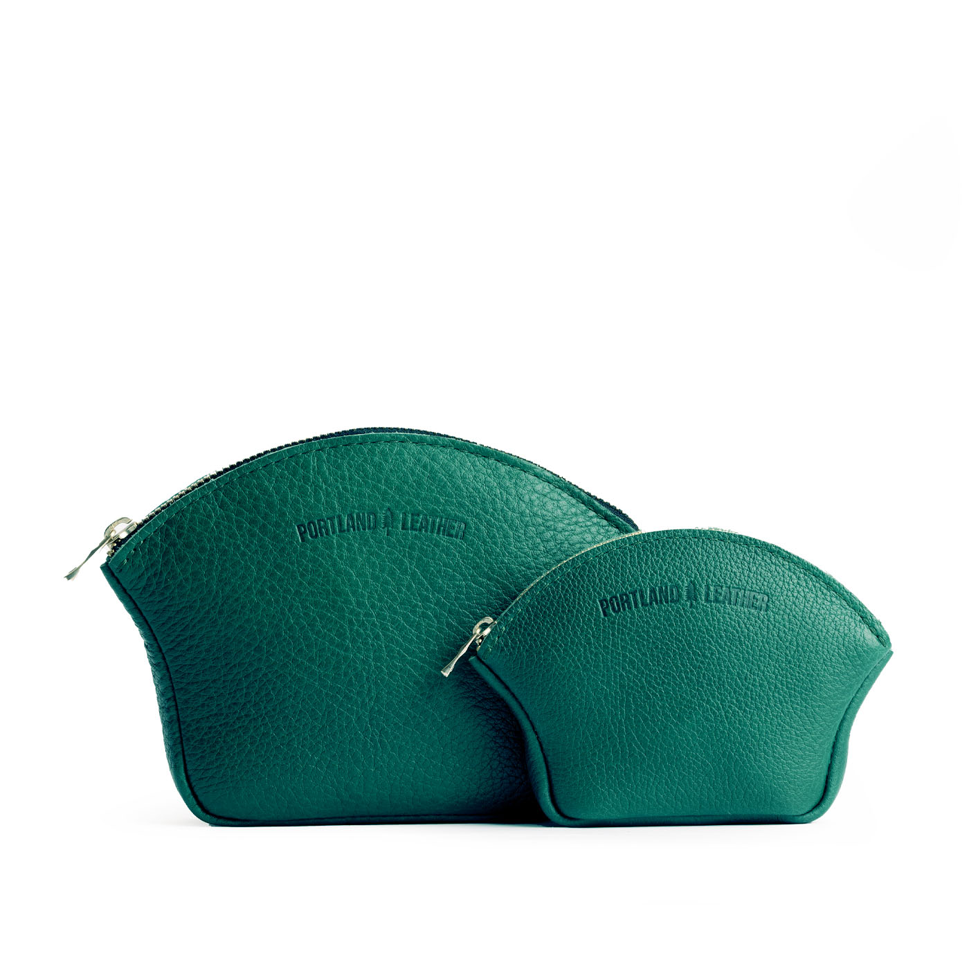 Bacalar | Comparison shot of small and large seashell shaped leather makeup bags with curved top zipper and flat bottom