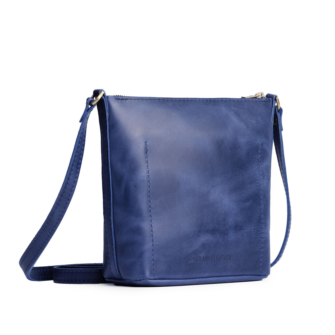 Cowboy Blue | Back of rectangular side bag with curved front pocket and metal tree shaped badge