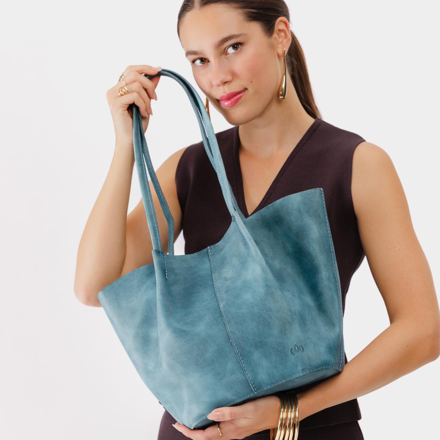 Aqua*Large | Model holding wide bucket shaped tote bag with matching leather handles