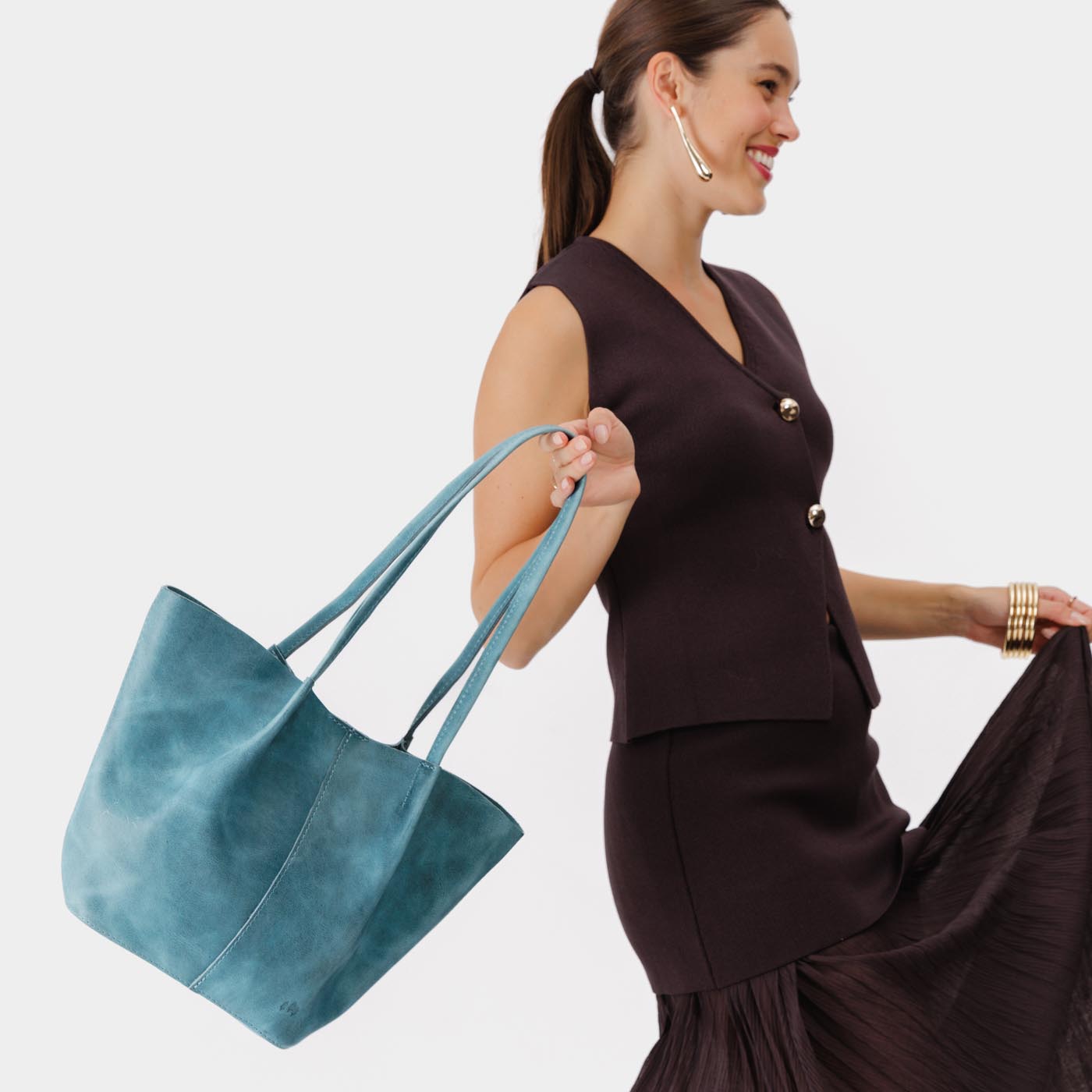 Aqua*Large | Model holding wide bucket shaped tote bag with matching leather handles