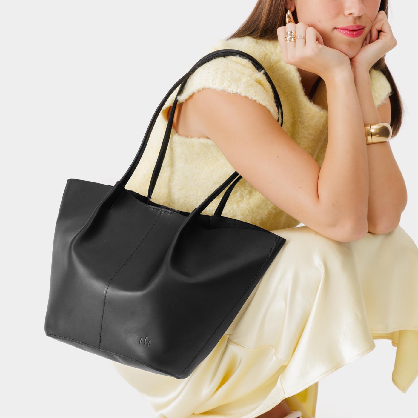 Black*Large | Model holding wide bucket shaped tote bag with matching leather handles