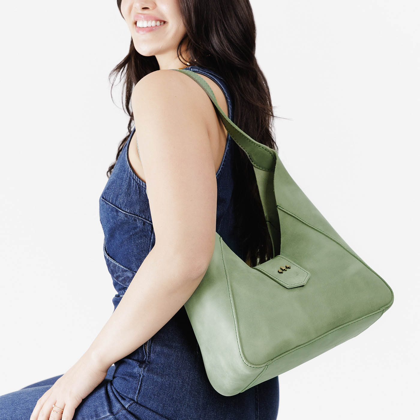 Cucumber | Model wearing structured hobo shoulder bag with adjustable strap and magnetic closure