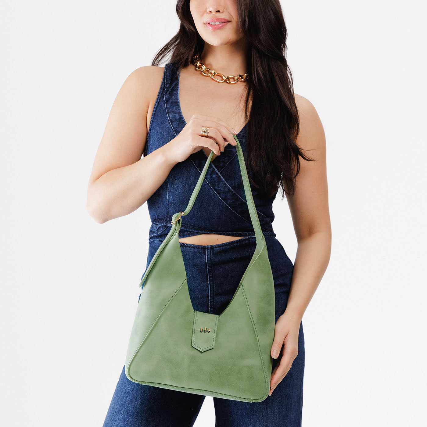 Cucumber | Model holding structured hobo shoulder bag with adjustable strap and magnetic closure