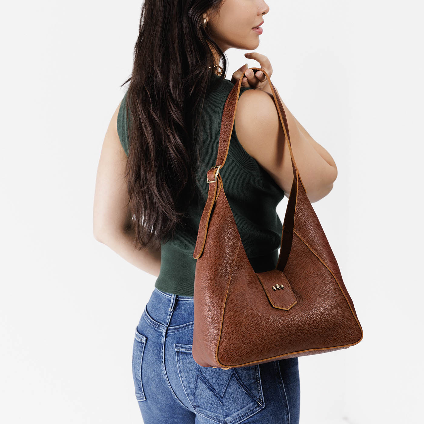 Nutmeg | Model wearing structured hobo shoulder bag with adjustable strap and magnetic closure