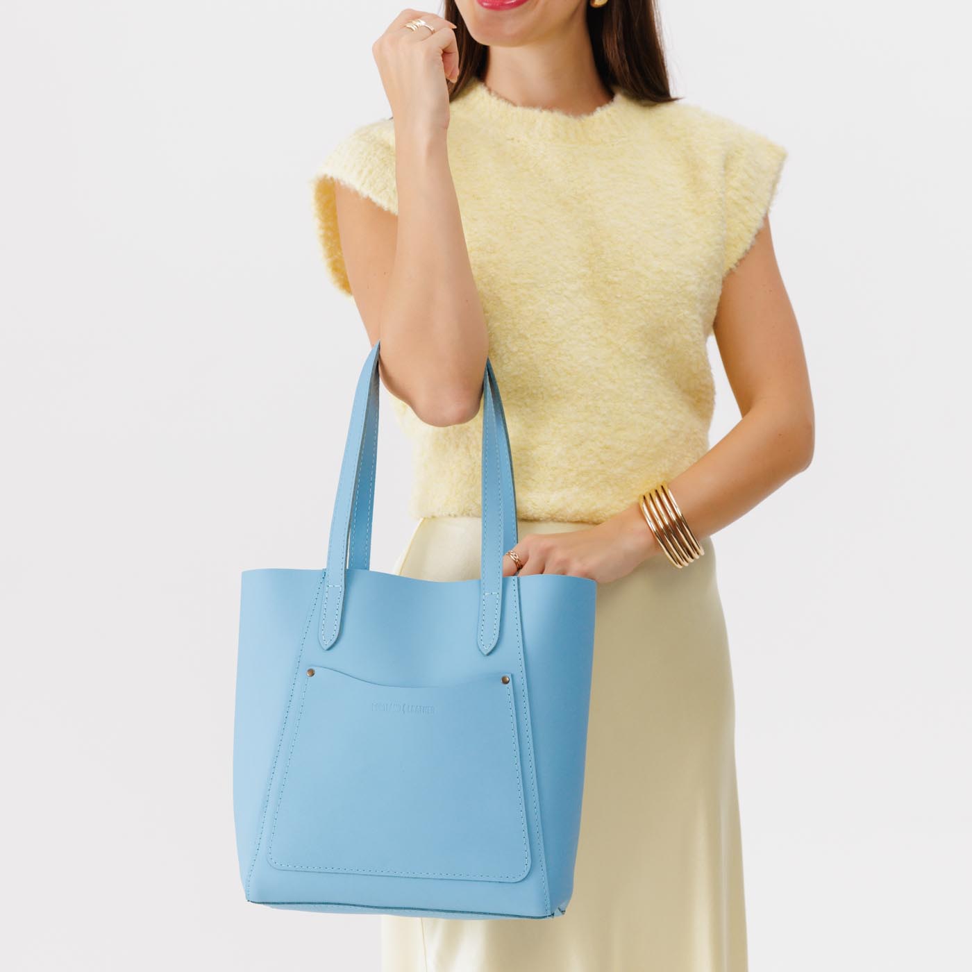 Glacial Blue*Large | Model holding dual shoulder strap tote bag with an exterior pocket