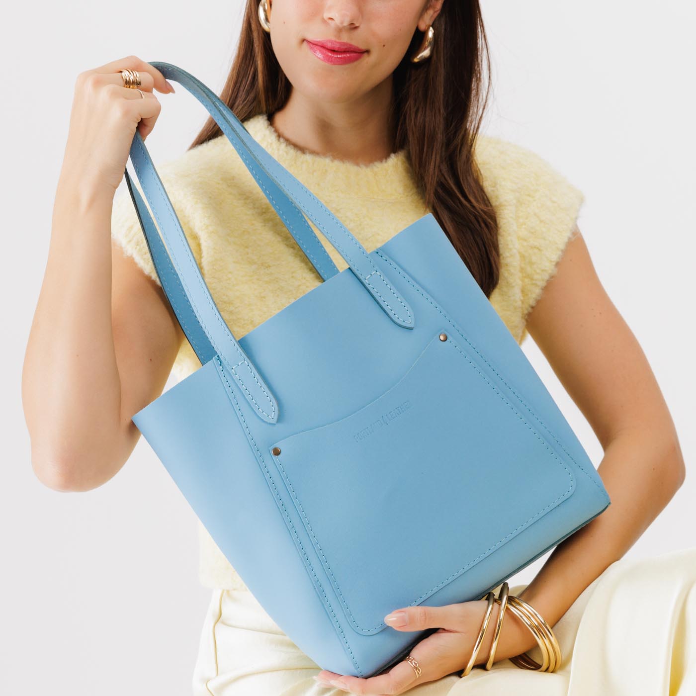 Glacial Blue*Large | Model holding dual shoulder strap tote bag with an exterior pocket