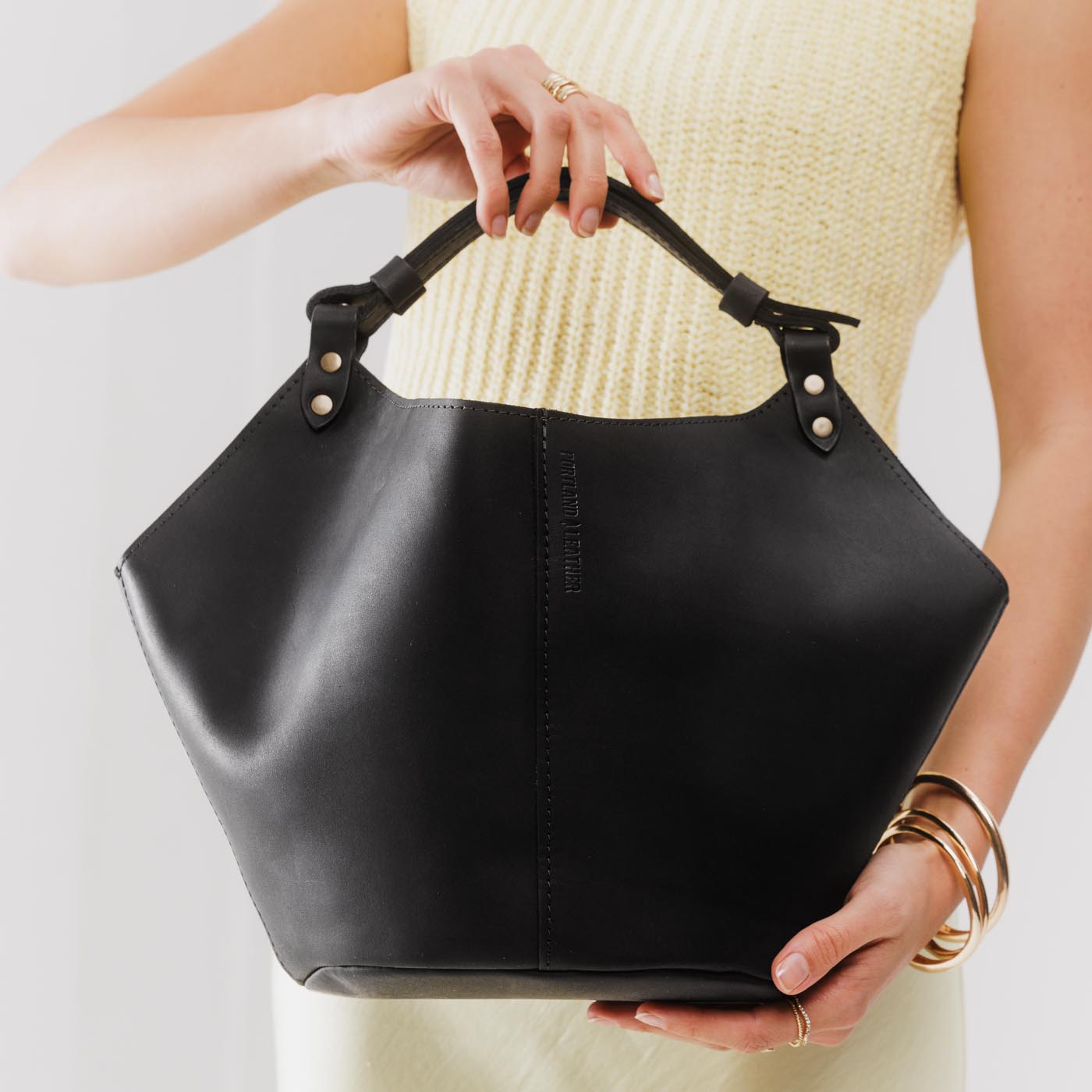 Black*Large | Structured bucket shaped handbag with an adjustable shoulder strap