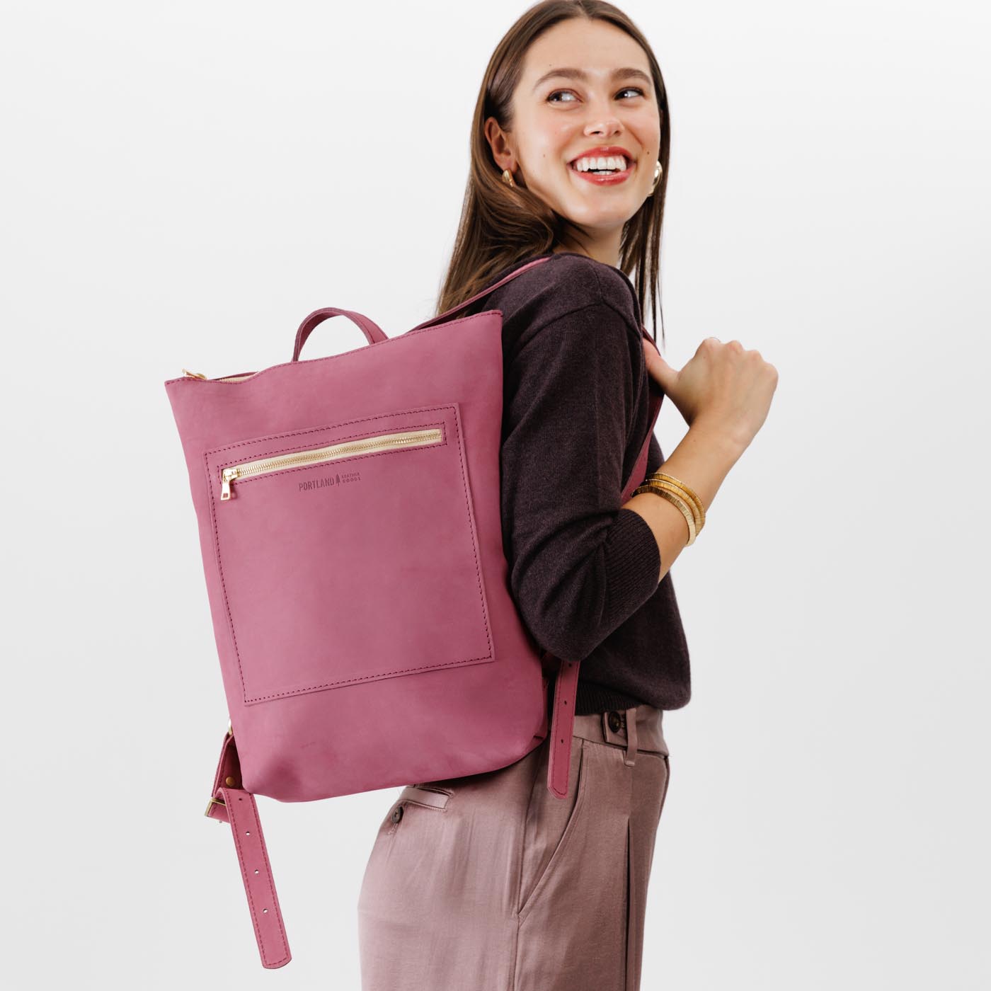 All Color: Foxglove | Model wearing rectangular slim leather laptop backpack