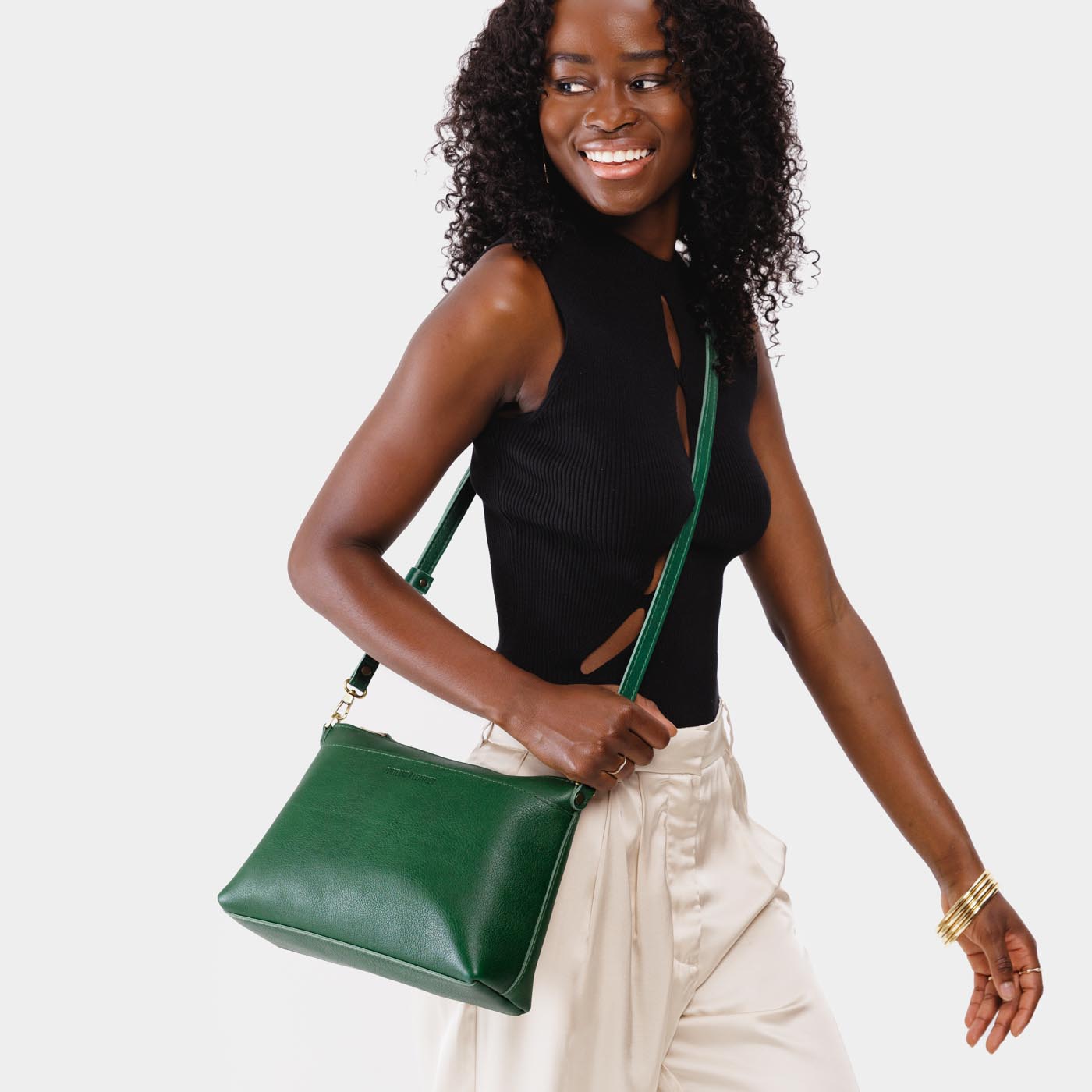 Bacalar | Model wearing midsize zip top crossbody bag with detachable strap