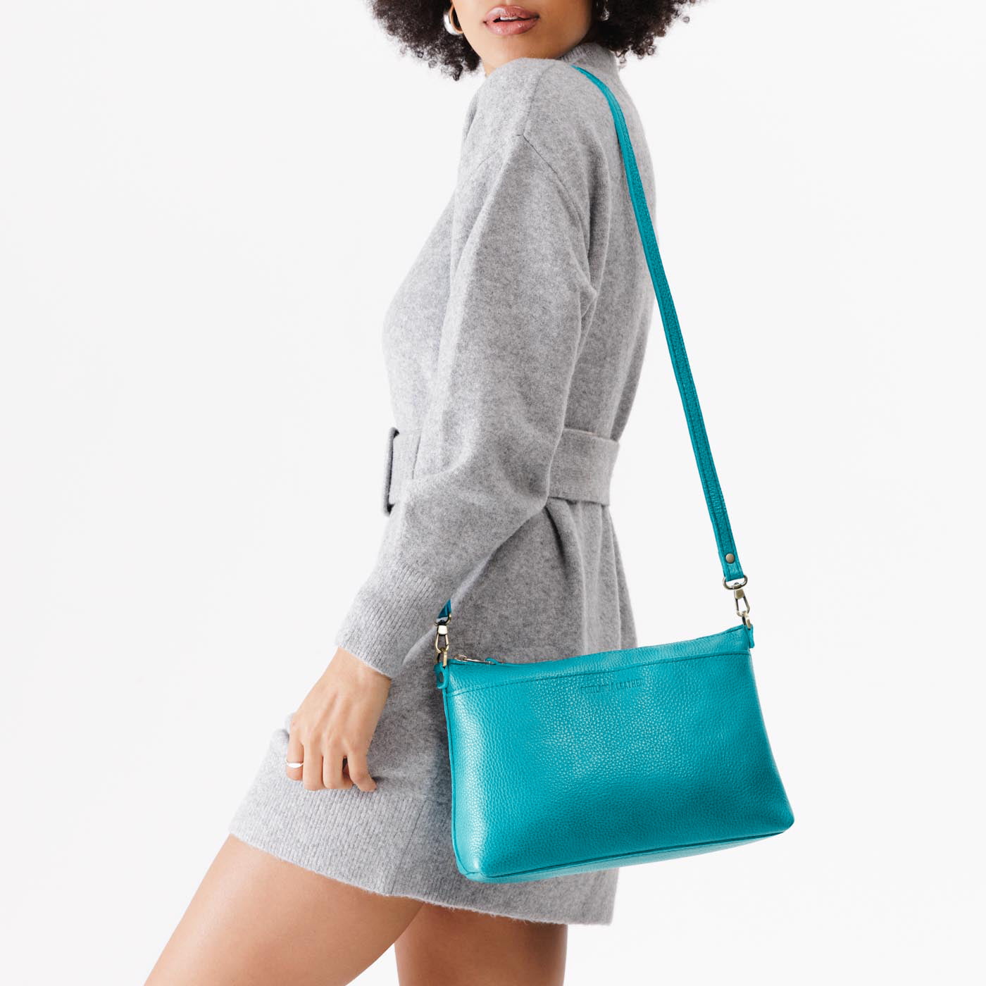 Baja | Model holding midsize zip top crossbody bag with detachable strap