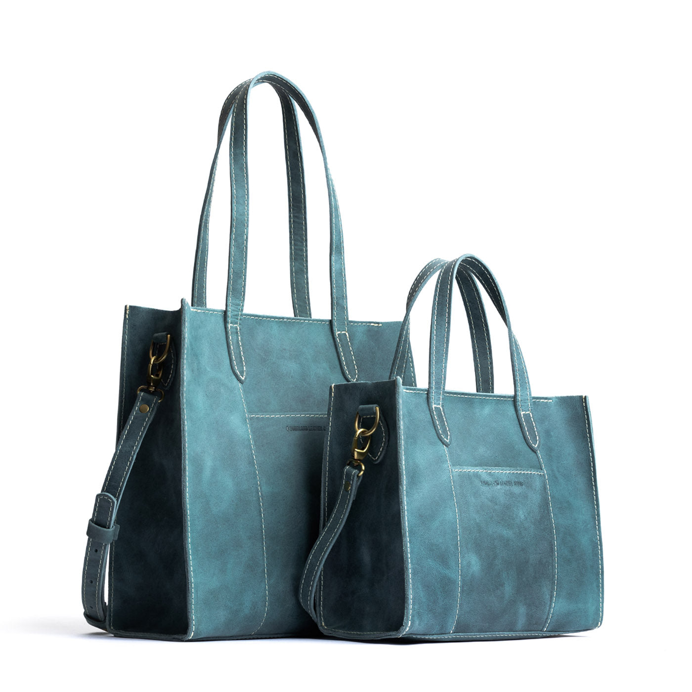 Aqua | Structured mid-size tote bag with overlapping panels and crossbody strap