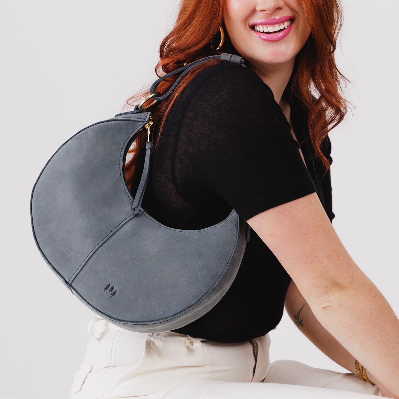 Storm*Classic | Crescent shaped shoulder bag with zipper closure and adjustable strap