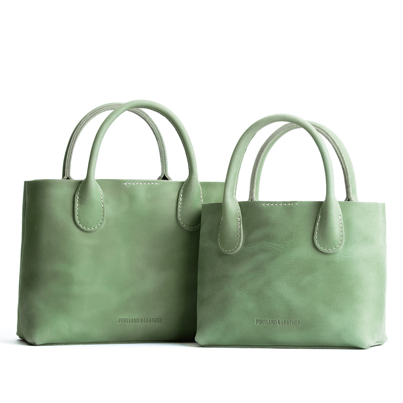 Cucumber | Side by side of both tote purses with structured leather handles and crossbody strap