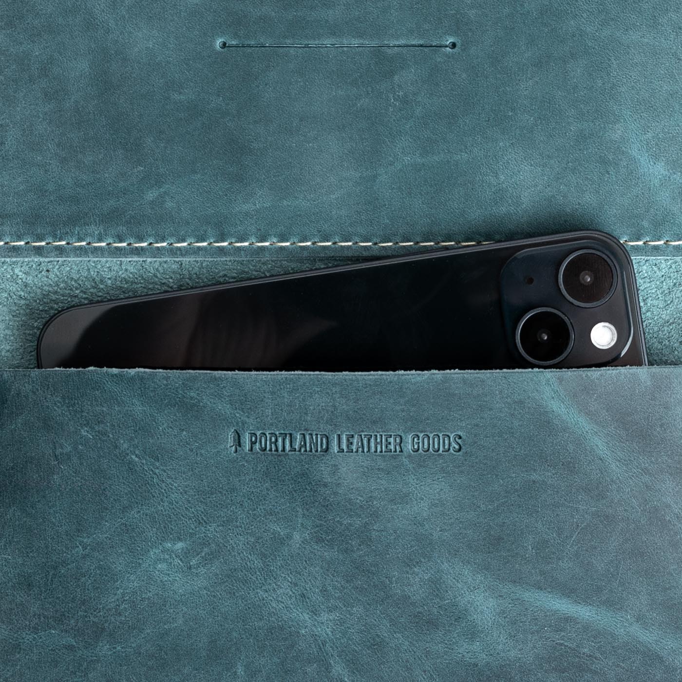 Aqua | Leather wallet inside pocket with iphone