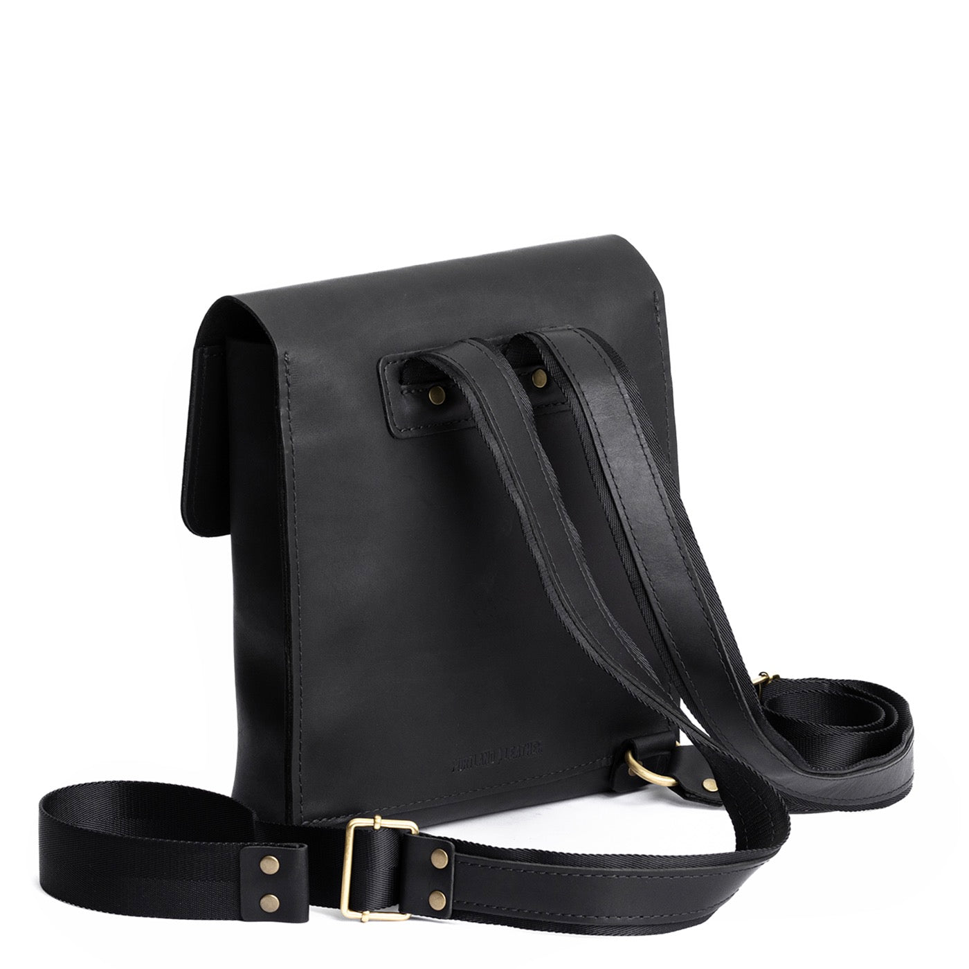 Black | Rectangular backpack with leather lined nylon straps and magnetic flap closure