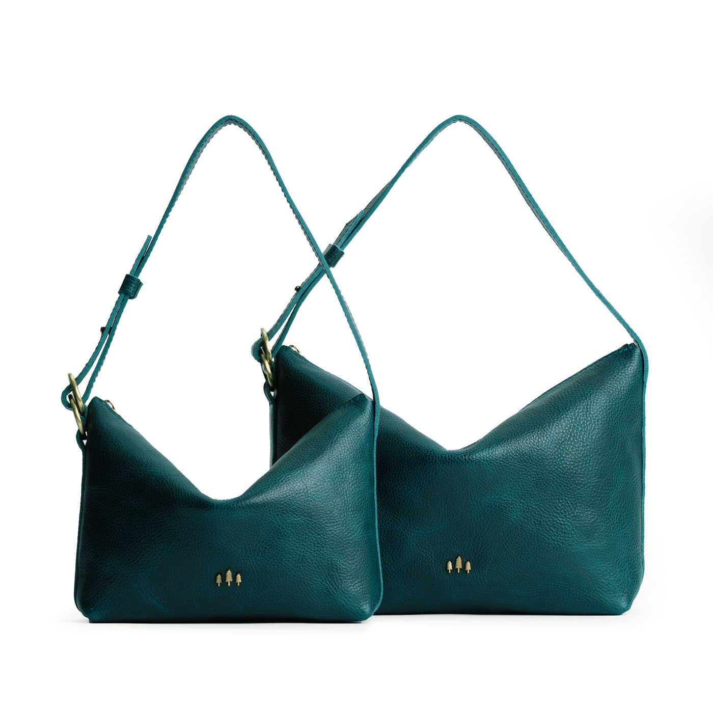 Lagoon | Size comparison shot of small and large slouchy leather shoulder bags with zipper opening and three metal tree emblems