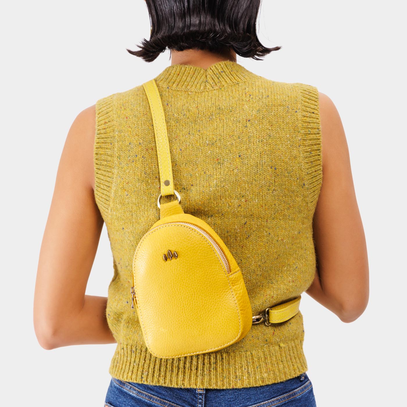 Naples | Model wearing small sling bag with zipper closure and adjustable strap