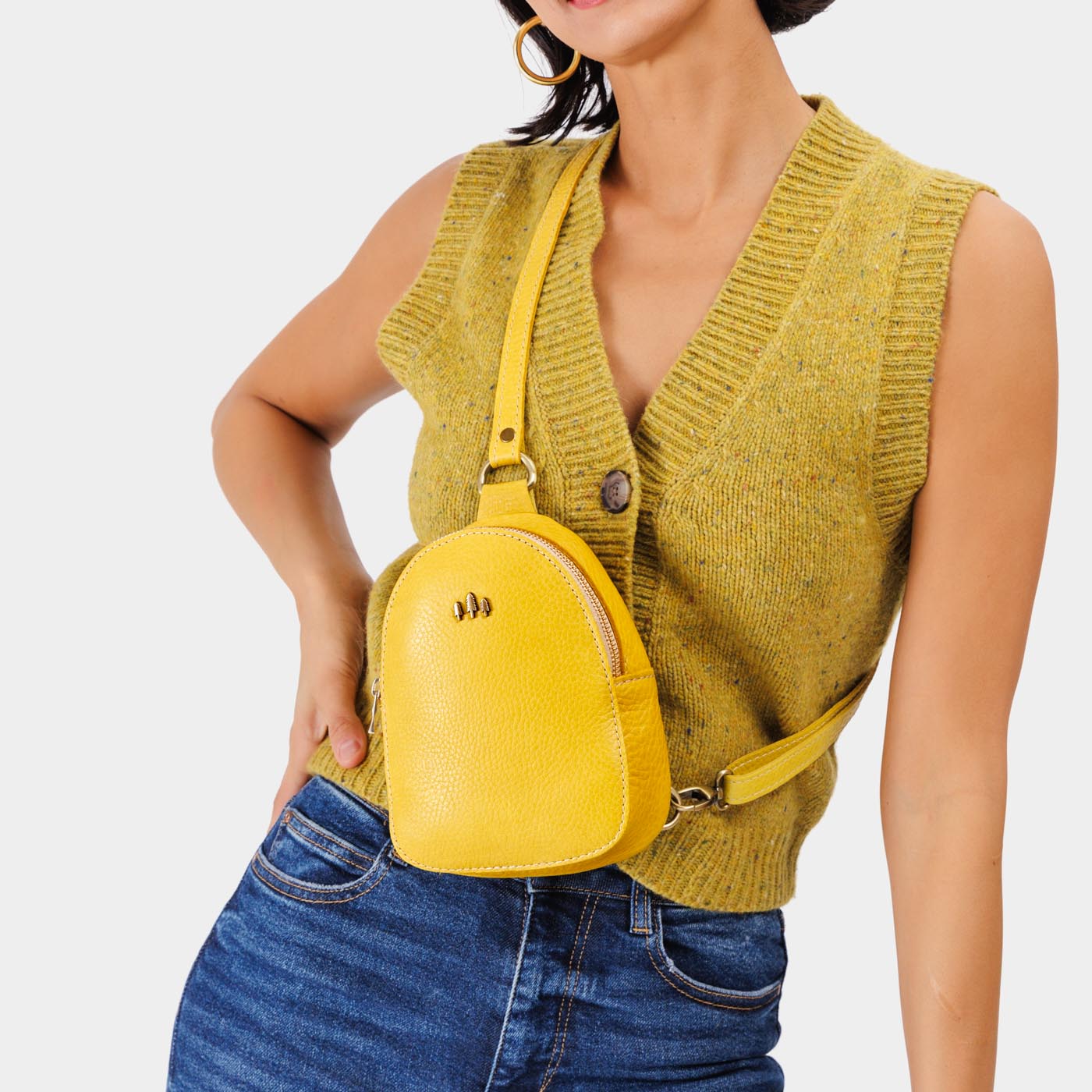 Naples | Model wearing small sling bag with zipper closure and adjustable strap