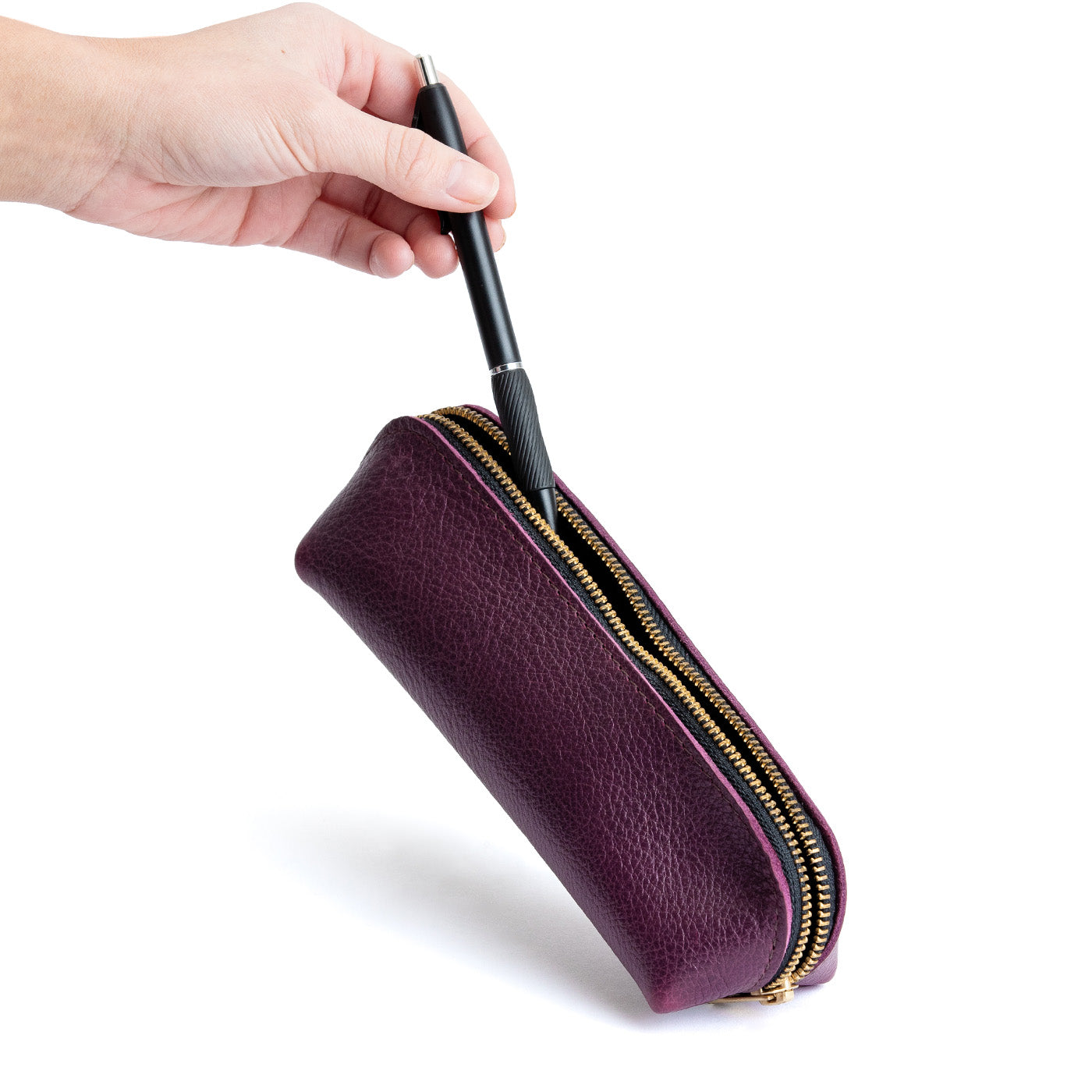 All Color: Plum | Leather pouch with curved seams and top zipper