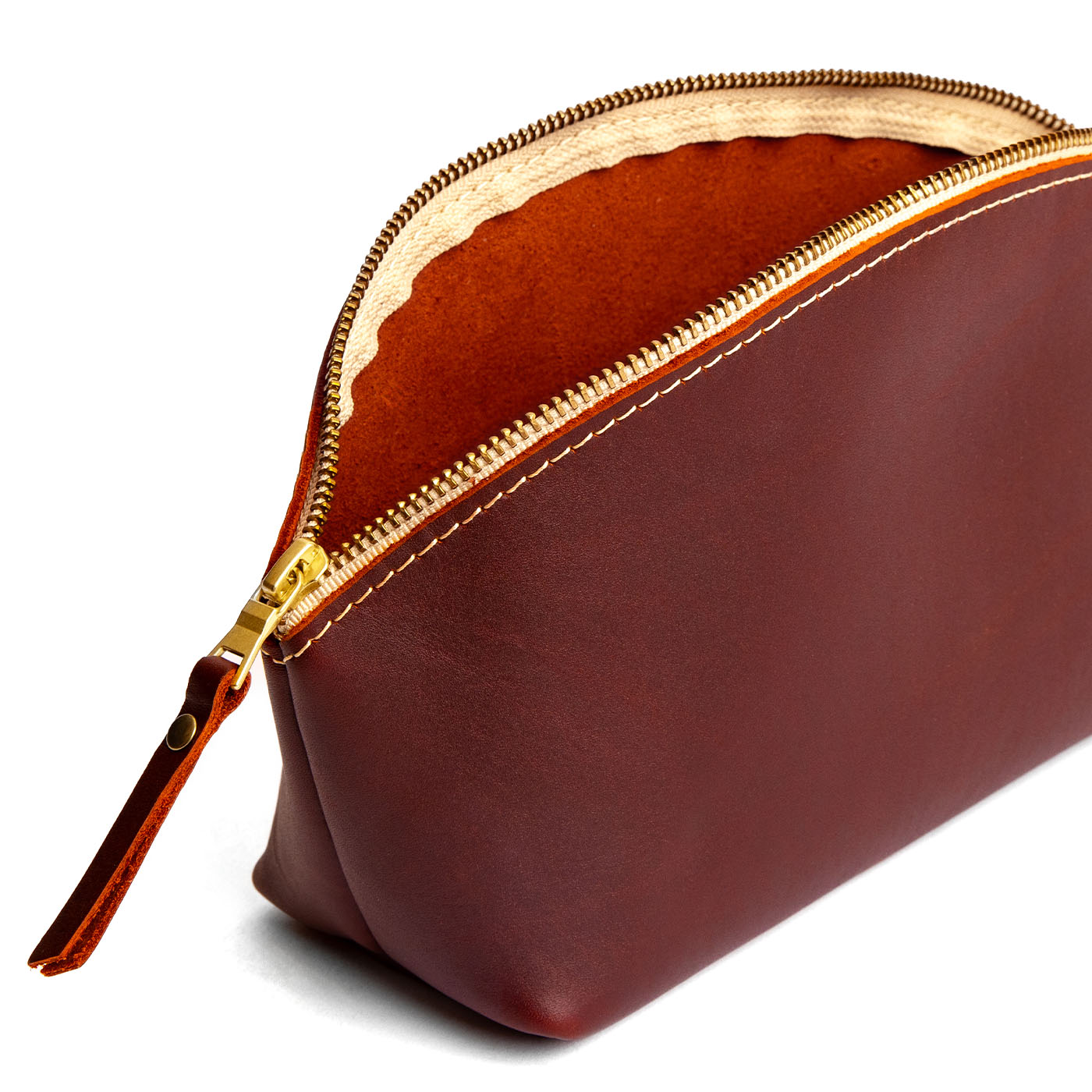 Cognac | Spacious leather makeup bag with curved seams and top zipper