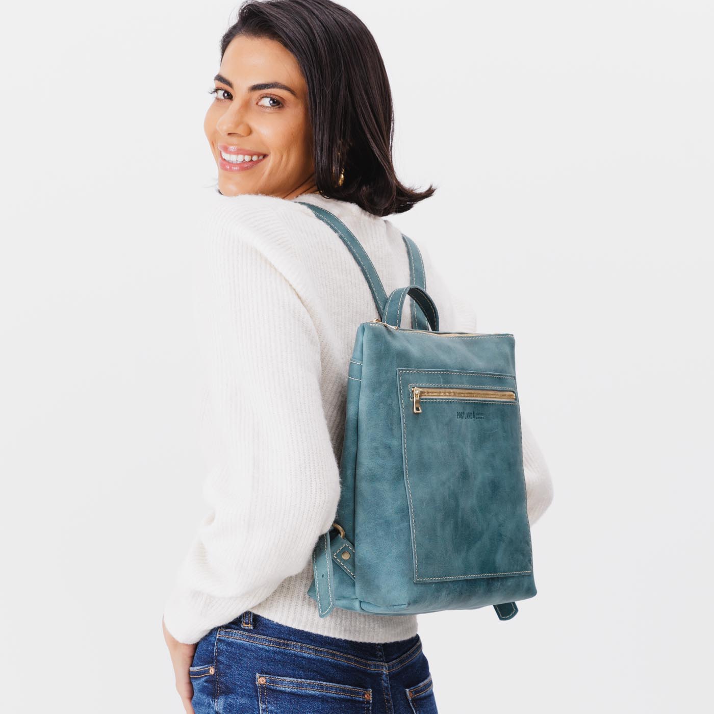 All Color: Aqua | Model wearing square slim leather tote backpack