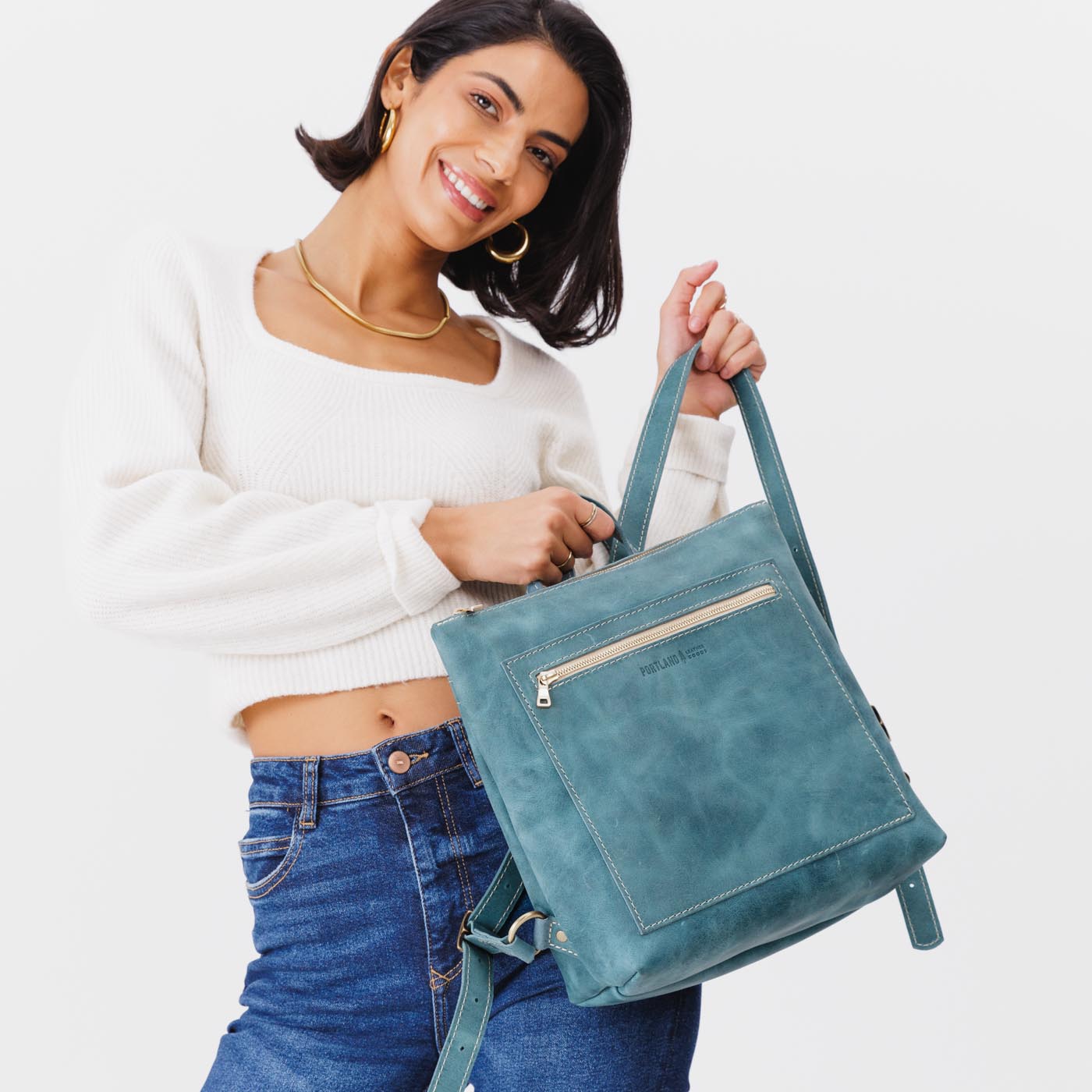 All Color: Aqua | Model holding square slim leather tote backpack