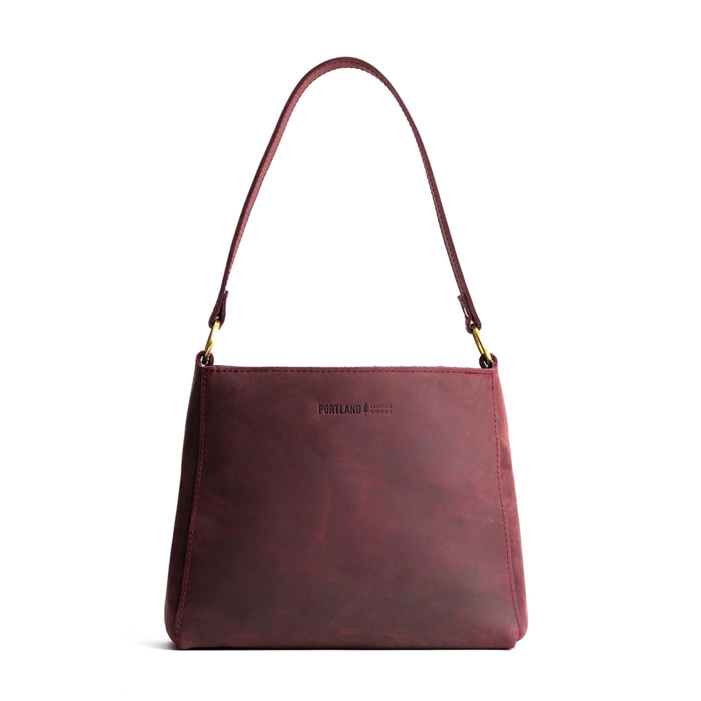 Merlot | Triangular shoulder bag with antiqued brass finished hardware