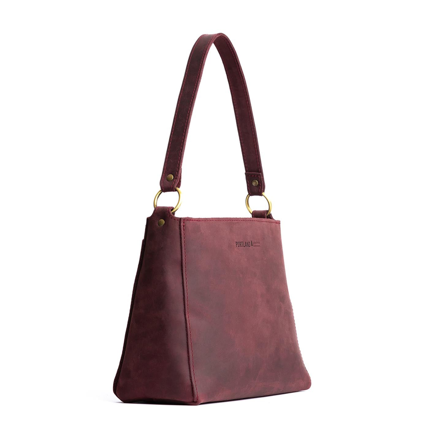 Merlot | Triangular shoulder bag with antiqued brass finished hardware