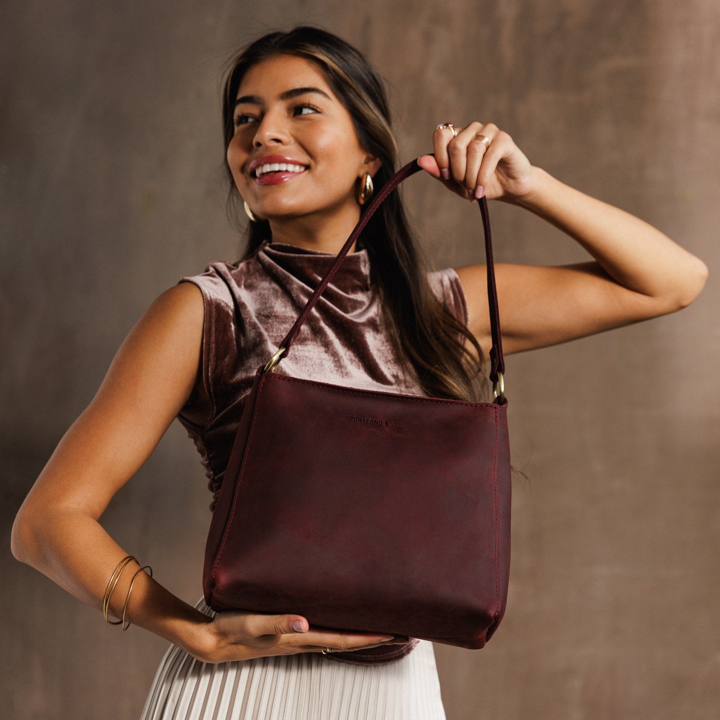  Merlot | Triangular shoulder bag with antiqued brass finished hardware