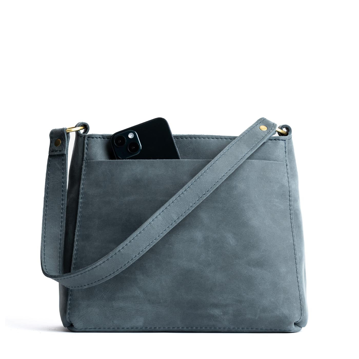 Storm | Triangular shoulder bag with antiqued brass finished hardware