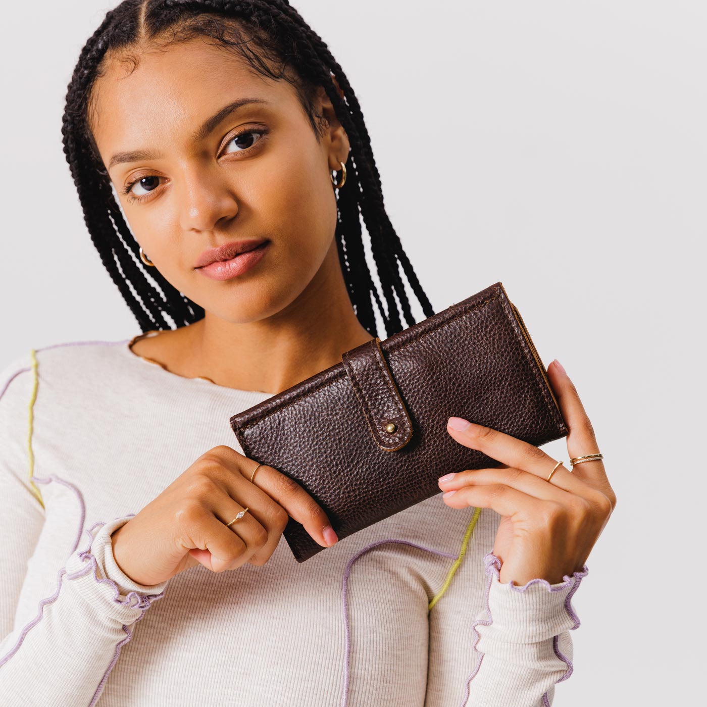 Coldbrew | Model holding leather wallet with Sam Browne closure