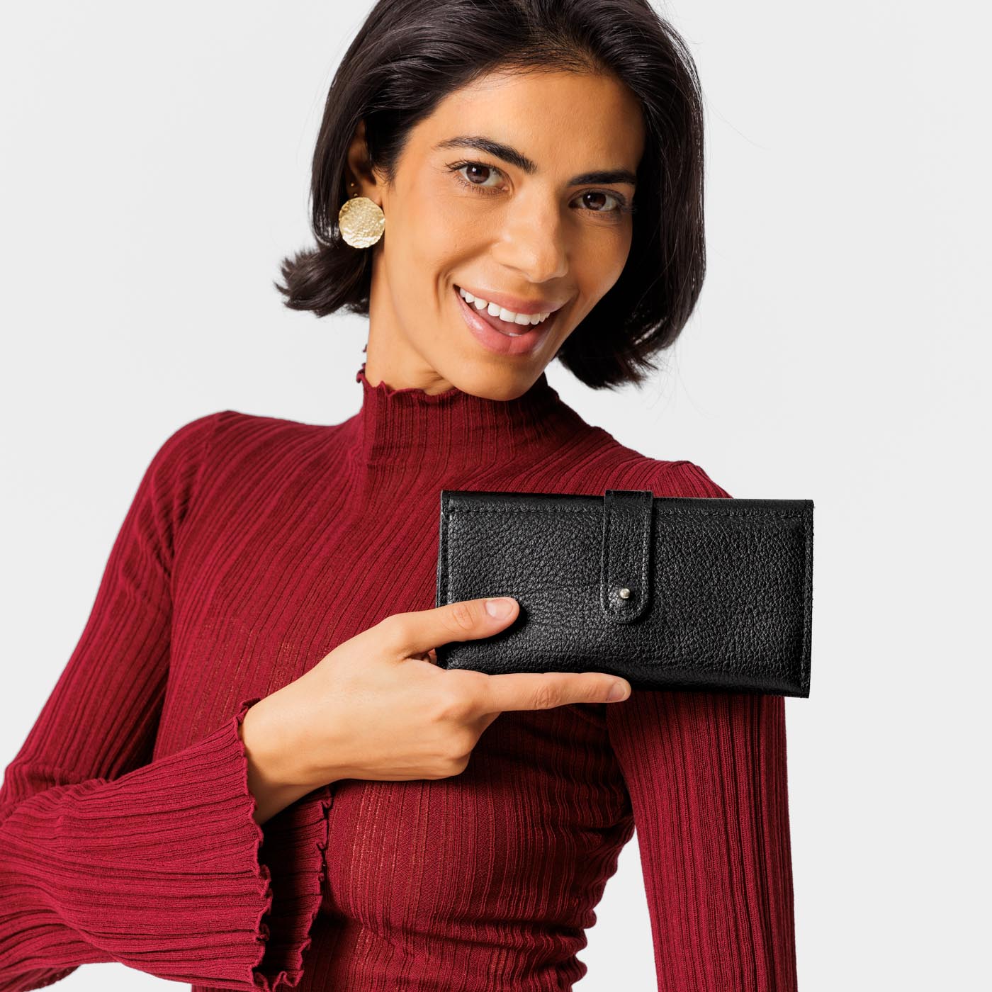 Pebbled--black | Model holding leather wallet with Sam Browne closure