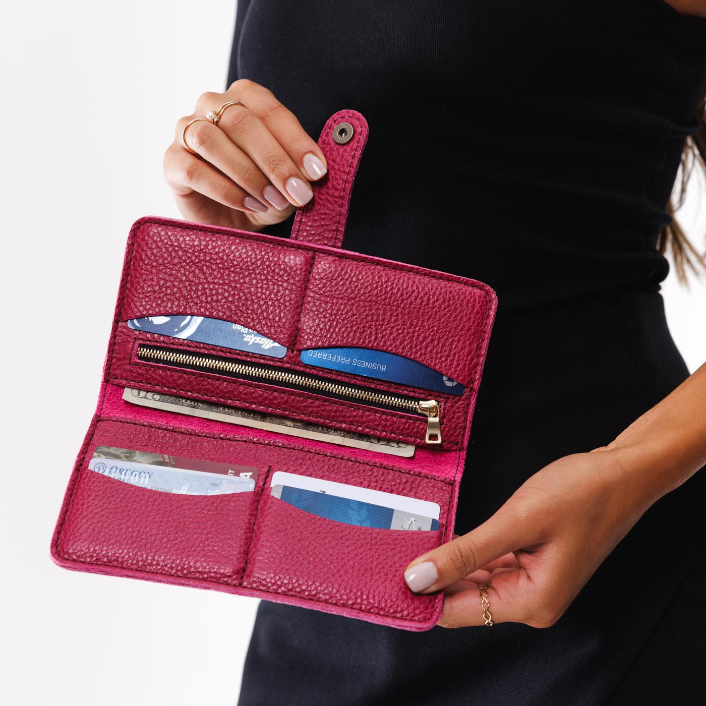 Cosmo | Model holding leather wallet with snap open