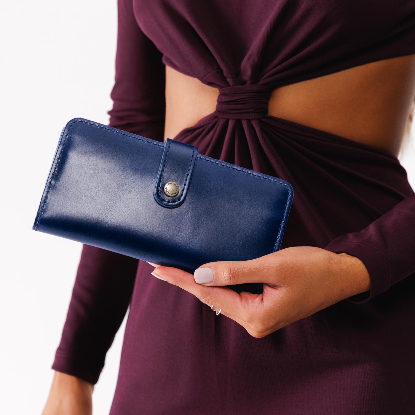 Cowboy Blue | Model holding leather wallet with snap closed