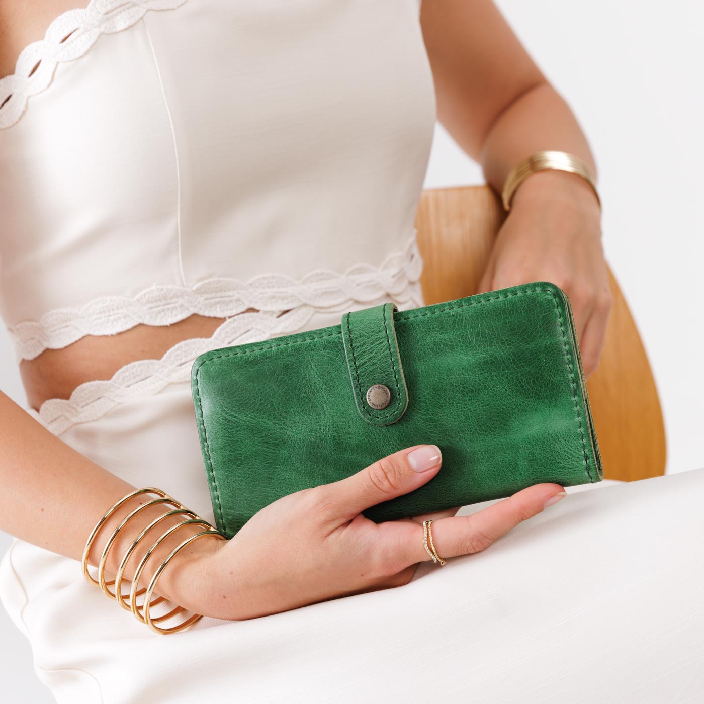 Cowboy MInt | Model holding leather wallet with snap closed