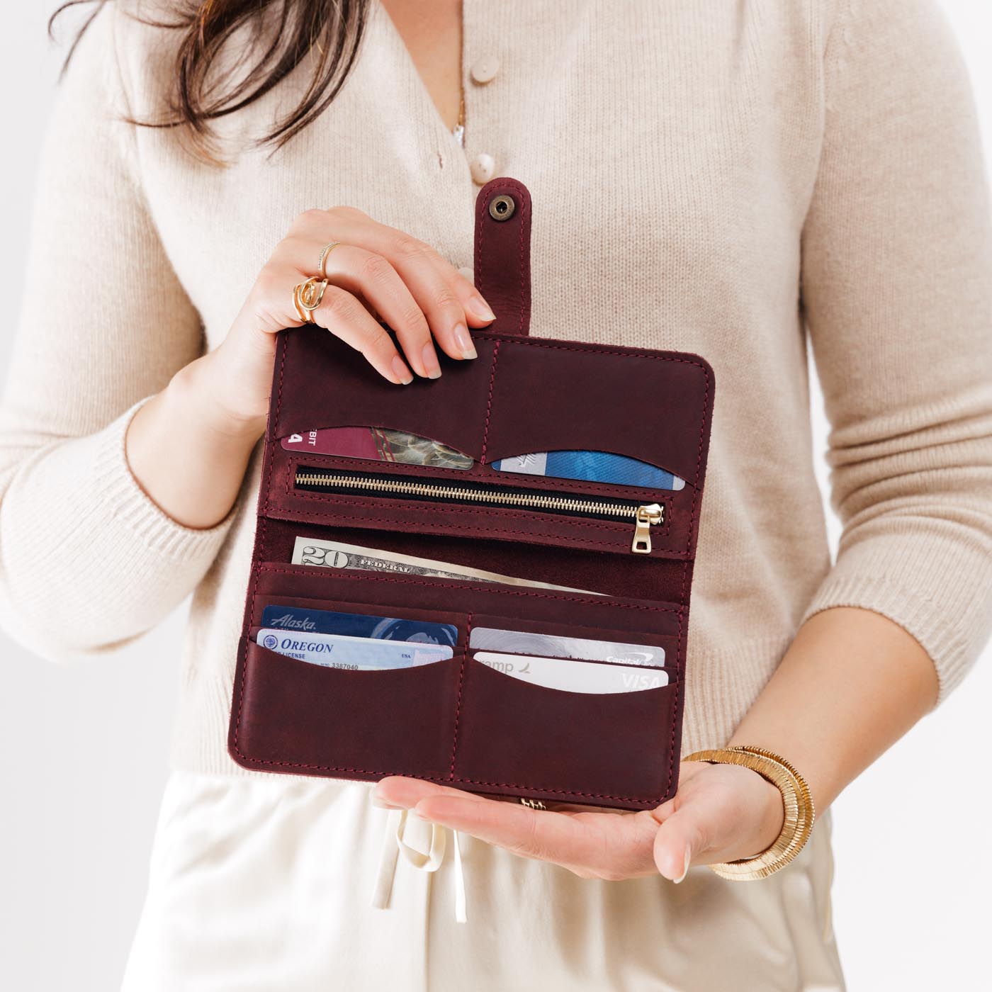 Merlot | Model holding leather wallet with snap open