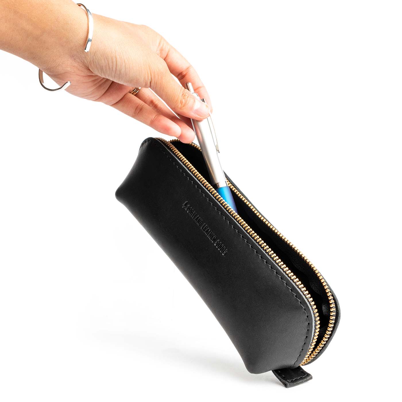 All Color: Black | Leather pouch with curved seams and top zipper