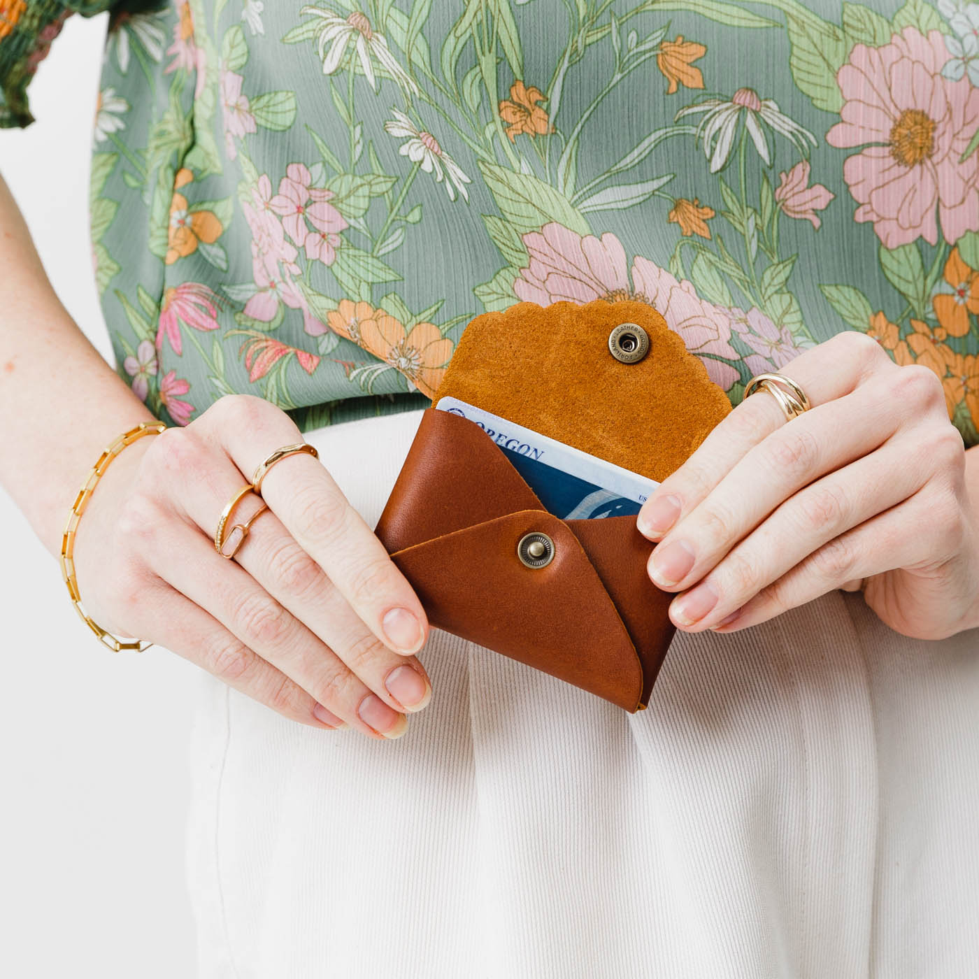 Honey | Model holding small leather wallet with scalloped edge open